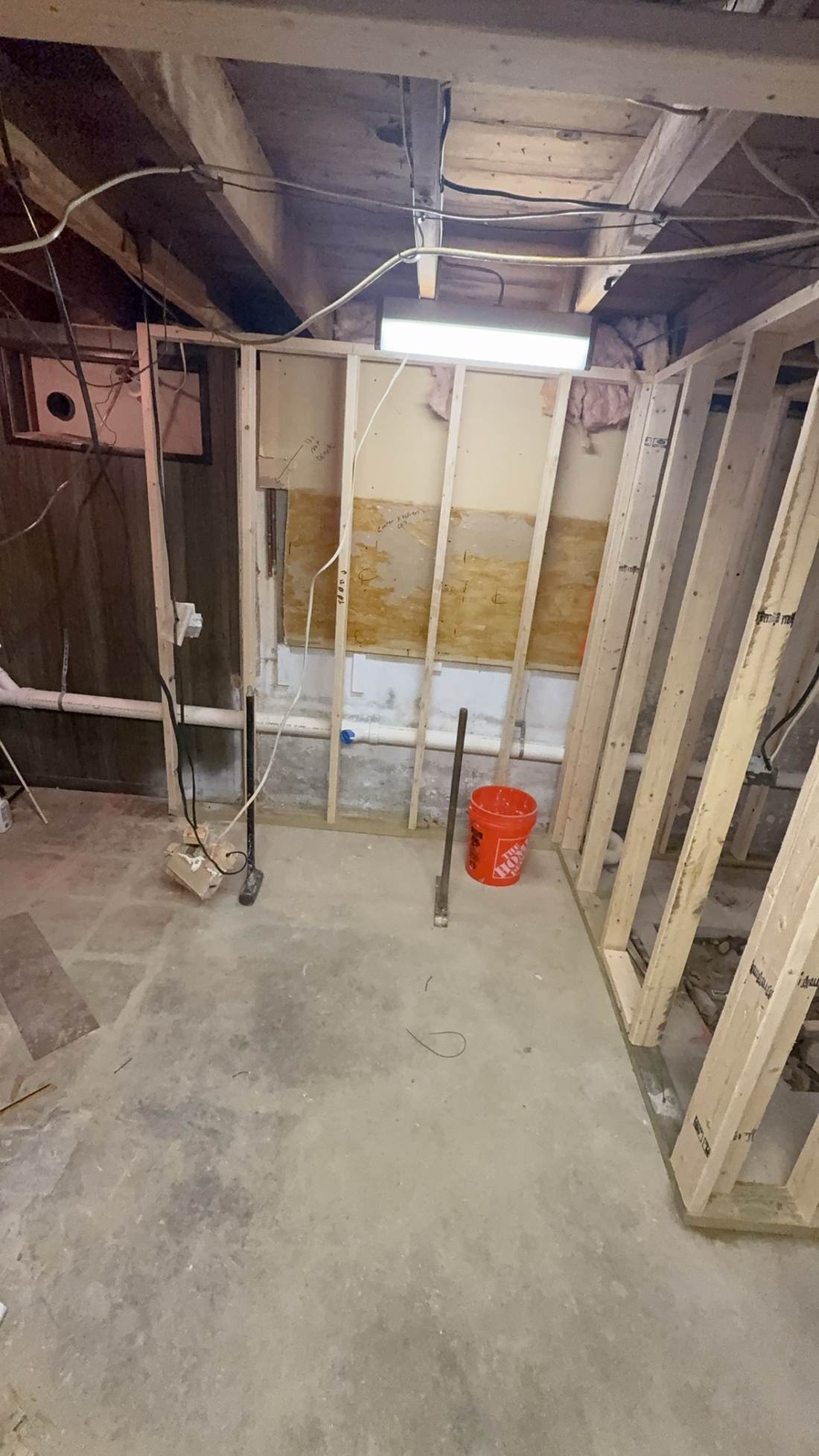 Basement room framed with new stud walls and utility rough-in