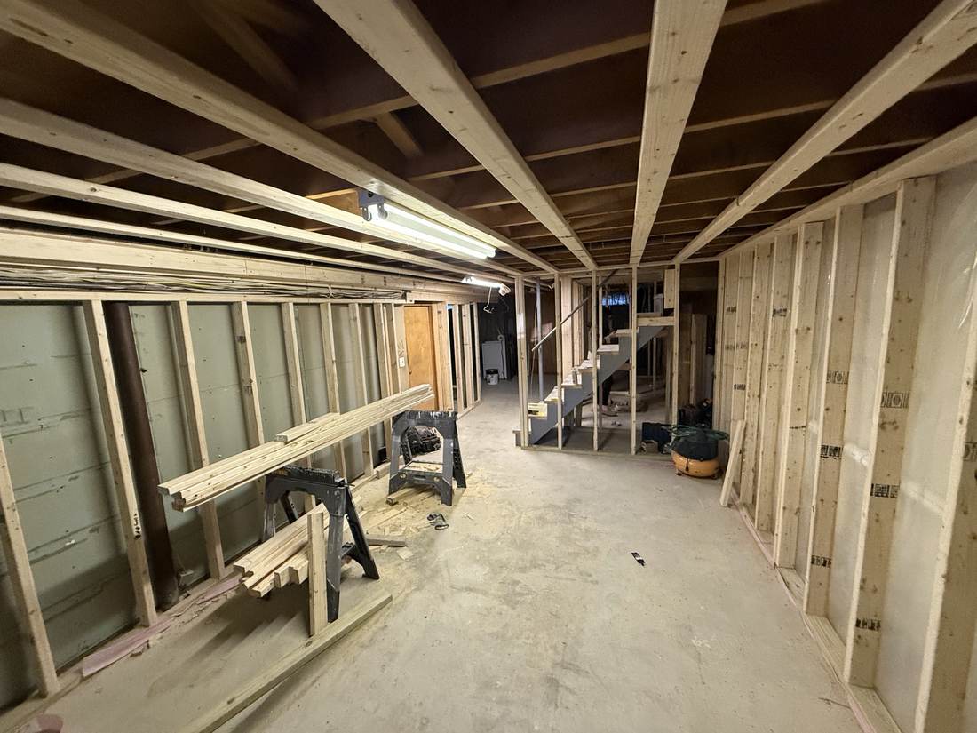 Wide basement hallway framed with new stairway visible