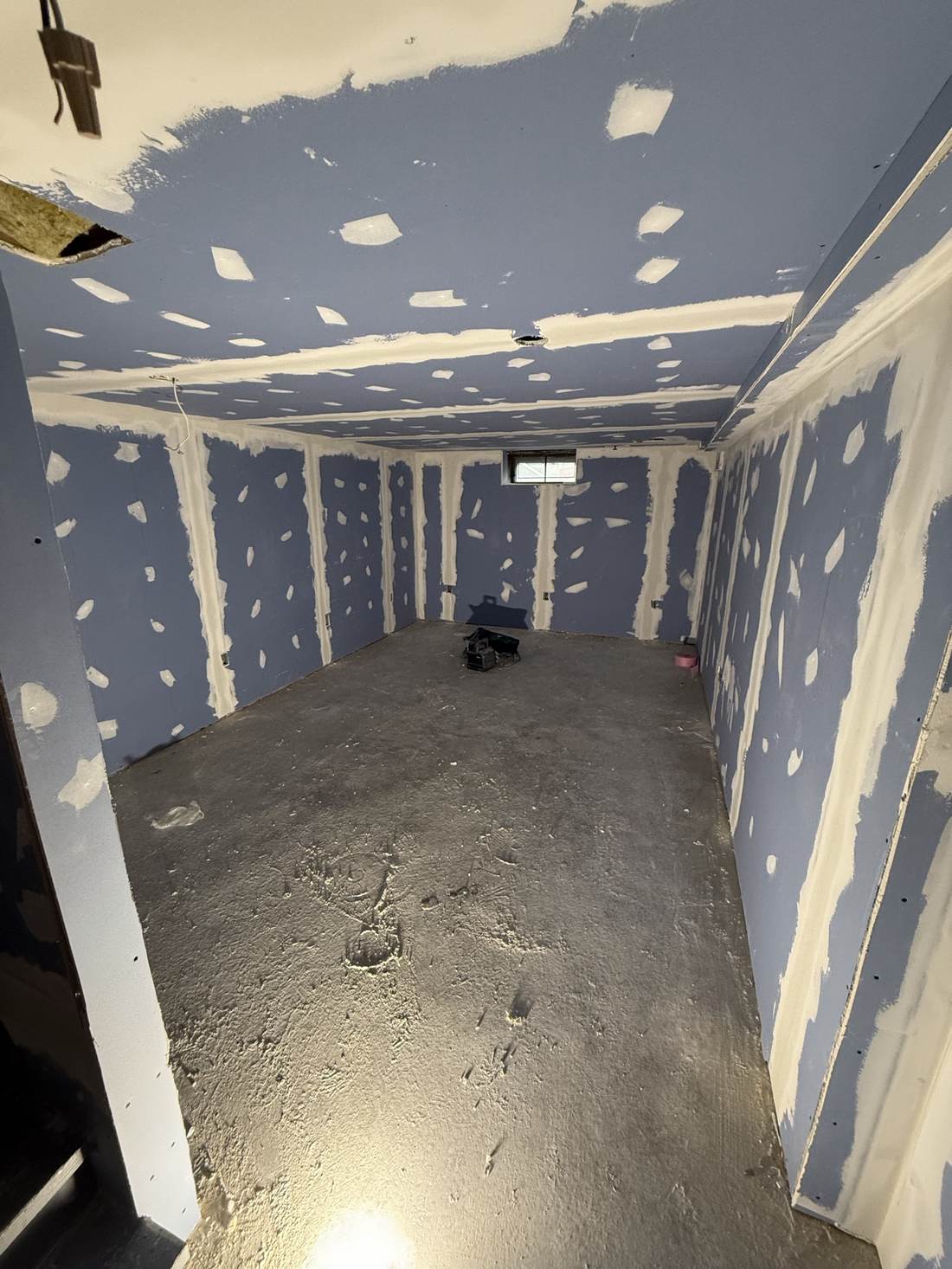 Basement room with drywall taped and mudded
