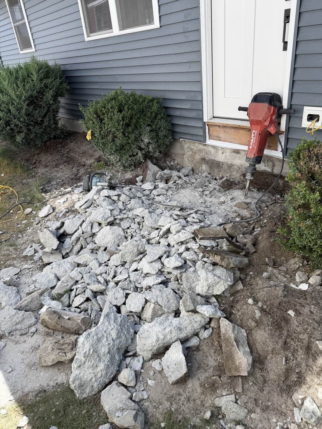 Old concrete entry steps broken up and removed