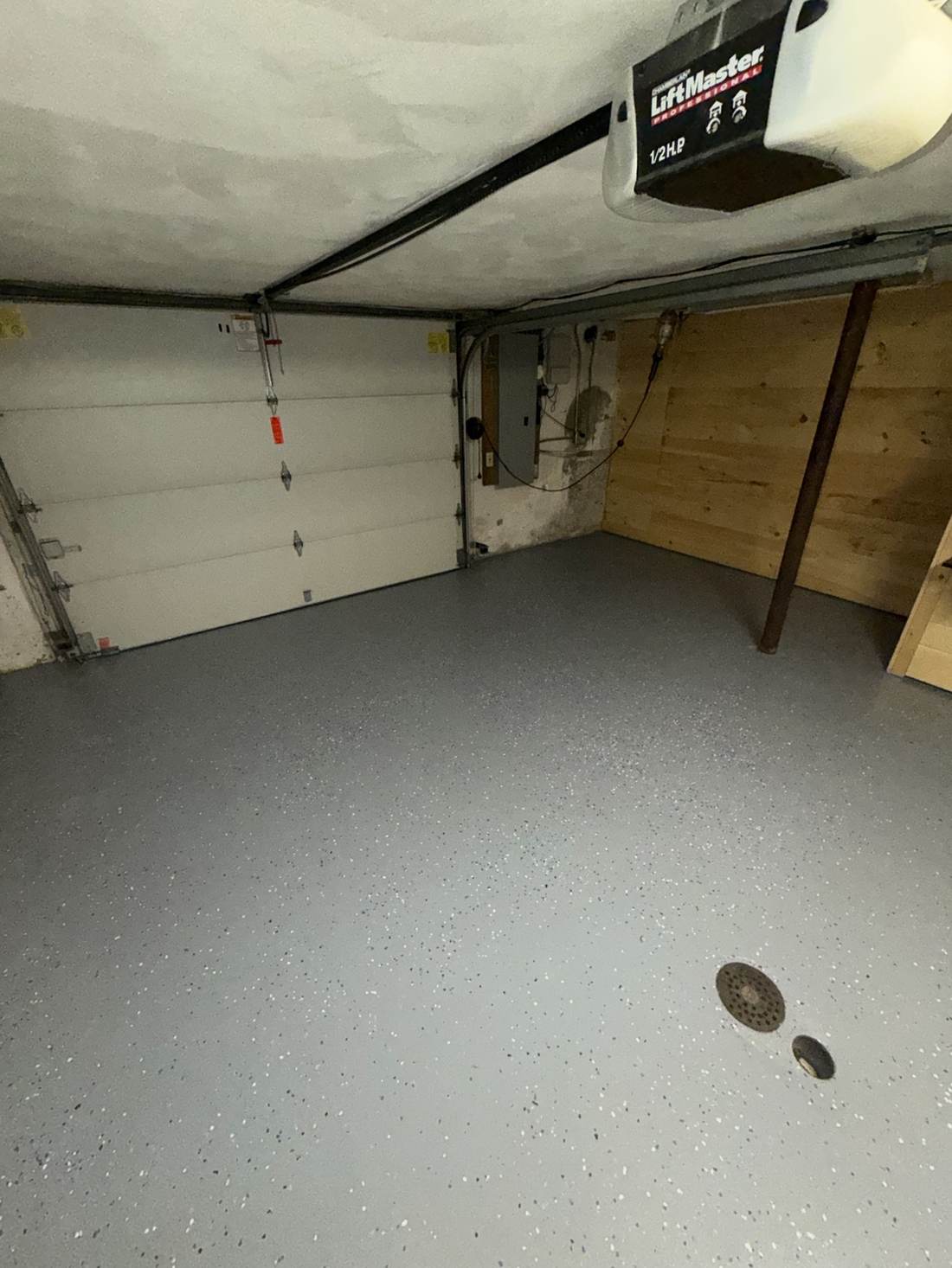 Finished garage with epoxy flake floor coating and built-in storage wall