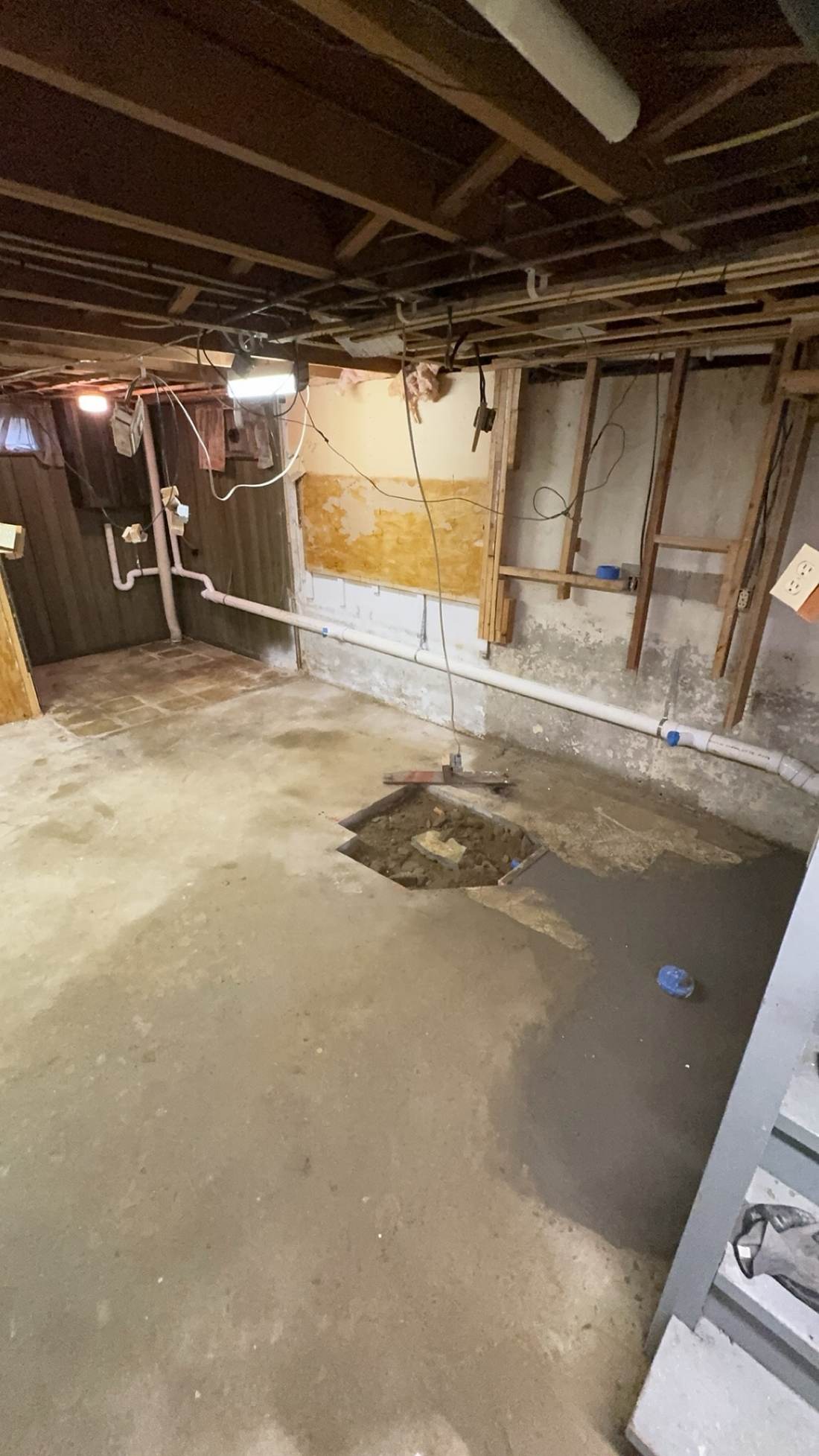 Rough plumbing pipes installed along a basement wall